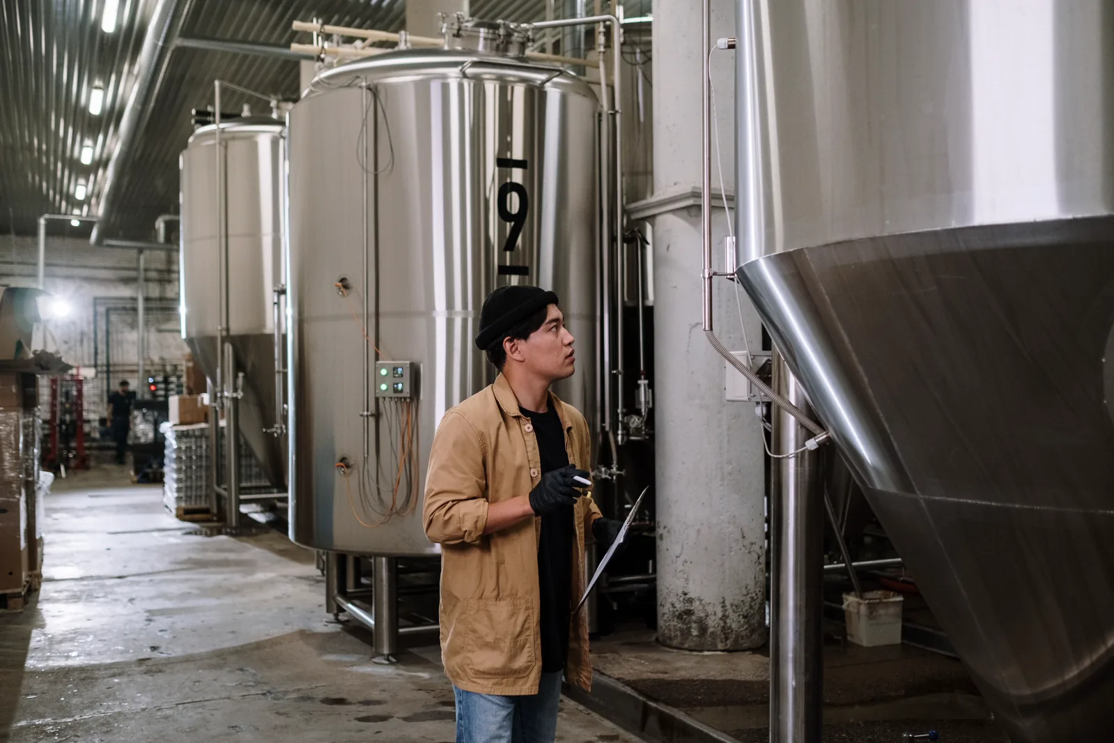 Engineer inspecting stainless steel processing equipment